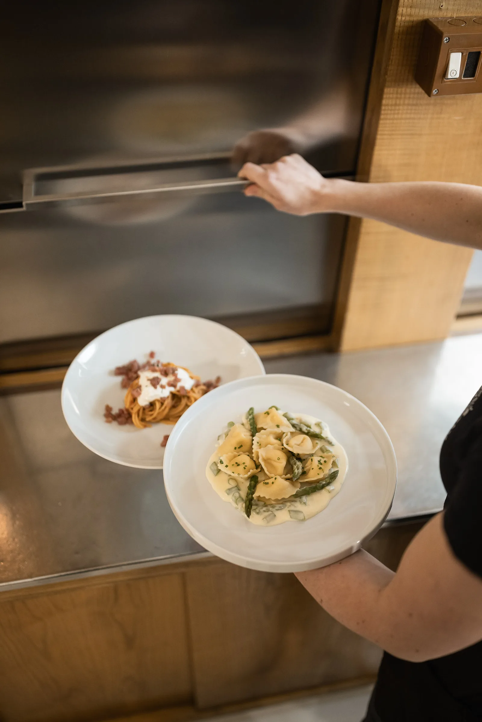 Two freshly plated dishes being served at Dorfgasthaus zur Linde